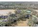 Scenic aerial view of a waterfront neighborhood, showcasing nearby tennis courts and mature trees at 1920 Mystic Bay Ct, Indianapolis, IN 46240