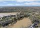 Expansive aerial view of waterfront neighborhood, surrounded by mature trees, and a distant city skyline at 1920 Mystic Bay Ct, Indianapolis, IN 46240