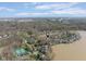 Panoramic aerial view of the neighborhood, showcasing waterfront homes, tennis courts and lush greenery at 1920 Mystic Bay Ct, Indianapolis, IN 46240