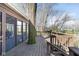 Wide view of wooden deck with access to the screened-in porch and backyard, surrounded by trees at 1920 Mystic Bay Ct, Indianapolis, IN 46240