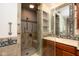 Bathroom shower featuring tile surround, glass door, seat and chrome shower fixture at 1920 Mystic Bay Ct, Indianapolis, IN 46240