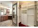 Bathroom with custom shower, walk-in closet, tile floors and vanity with dual sinks at 1920 Mystic Bay Ct, Indianapolis, IN 46240
