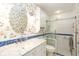 Bright bathroom featuring a glass enclosed shower, bird-themed wallpaper, and a white vanity with a round mirror at 1920 Mystic Bay Ct, Indianapolis, IN 46240
