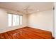 Bright bedroom with hardwood floors, ceiling fan, and a large window for natural light at 1920 Mystic Bay Ct, Indianapolis, IN 46240