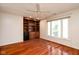 Bedroom featuring hardwood floors, ceiling fan, large window and built in shelving at 1920 Mystic Bay Ct, Indianapolis, IN 46240