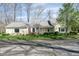 Charming, sunlit home featuring a well-manicured lawn and inviting curb appeal on a tree-lined street at 1920 Mystic Bay Ct, Indianapolis, IN 46240