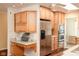 Kitchen with wooden cabinets, stainless steel refrigerator, double oven and built in desk at 1920 Mystic Bay Ct, Indianapolis, IN 46240