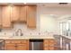 Bright kitchen featuring wooden cabinets, stainless steel dishwasher and tile backsplash at 1920 Mystic Bay Ct, Indianapolis, IN 46240