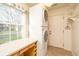 Laundry room with stacked washer and dryer, counter space and natural light from the window at 1920 Mystic Bay Ct, Indianapolis, IN 46240
