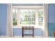 Sun-drenched living room featuring a large bay window with white curtains offering a view of the well-manicured front yard at 1920 Mystic Bay Ct, Indianapolis, IN 46240