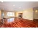 Bright living room with hardwood floors, a fireplace, and a large bay window at 1920 Mystic Bay Ct, Indianapolis, IN 46240