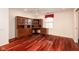 Spacious office featuring hardwood floors, a ceiling fan and a large built-in wooden desk and cabinets at 1920 Mystic Bay Ct, Indianapolis, IN 46240