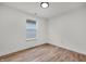 This bedroom features wood-look flooring and a large window, offering ample natural light at 2041 N Dexter St, Indianapolis, IN 46202