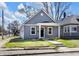 Charming single-story home with gray siding, a front porch, and a newly installed sidewalk at 2041 N Dexter St, Indianapolis, IN 46202