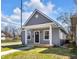 Charming home featuring a covered front porch, gray siding, and a well-manicured lawn, creating a welcoming curb appeal at 2041 N Dexter St, Indianapolis, IN 46202