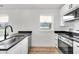 Clean kitchen design with stainless steel appliances, white cabinets and countertops at 2041 N Dexter St, Indianapolis, IN 46202