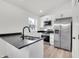 Well-lit kitchen features stainless steel appliances, white cabinets, and dark countertops at 2041 N Dexter St, Indianapolis, IN 46202