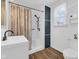 Bright bathroom featuring a shower, sink with modern fixtures, and a window for ample natural light at 211 N Merrill St, Fortville, IN 46040