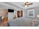 Large bedroom with ceiling fan, closet, and views to the living room and bathroom at 211 N Merrill St, Fortville, IN 46040