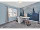 Comfortable bedroom features a desk, chair, and an accent wall with a mural of trees at 211 N Merrill St, Fortville, IN 46040