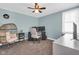 Bedroom with a ceiling fan, a side chair, and a white storage dresser at 211 N Merrill St, Fortville, IN 46040