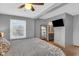 Spacious bedroom with ceiling fan, closet, and view to ensuite bathroom at 211 N Merrill St, Fortville, IN 46040