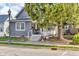 Quaint home with a welcoming front porch and mature trees, offering a peaceful setting at 211 N Merrill St, Fortville, IN 46040