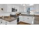 Bright kitchen with granite countertops, white cabinetry and stainless steel appliances at 211 N Merrill St, Fortville, IN 46040