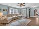 Comfortable living room boasts an attractive ceiling fan and a large sectional sofa at 211 N Merrill St, Fortville, IN 46040