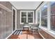 Cozy sunroom featuring natural light, wood-look walls, and a seating area at 211 N Merrill St, Fortville, IN 46040