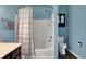 Bathroom featuring a shower-tub combo, toilet, vanity with solid surface, and black fixtures at 2307 Cedarmill Dr, Franklin, IN 46131
