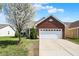 Charming brick home featuring an attached two-car garage and a well-maintained front lawn at 2307 Cedarmill Dr, Franklin, IN 46131