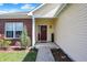 Welcoming front porch featuring a colorful wreath, 'home' doormat, and brick and vinyl siding at 2307 Cedarmill Dr, Franklin, IN 46131
