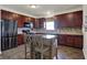 Elegant kitchen featuring dark wood cabinets, a stainless steel refrigerator, and a functional island at 2307 Cedarmill Dr, Franklin, IN 46131