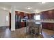 Well-lit kitchen with stainless steel appliances, granite countertops, tile backsplash, and island with seating at 2307 Cedarmill Dr, Franklin, IN 46131