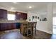 Spacious kitchen with dark wood cabinets, a central island with barstools, and hardwood floors at 2307 Cedarmill Dr, Franklin, IN 46131
