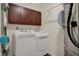Laundry room with washer, dryer, storage cabinets, and folding rack at 2307 Cedarmill Dr, Franklin, IN 46131