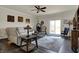 Comfortable living room featuring hardwood floors, ceiling fan, and sliding doors to backyard deck at 2307 Cedarmill Dr, Franklin, IN 46131