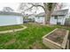 Spacious backyard with mature tree, storage shed, and garden bed at 2317 St Peter St, Indianapolis, IN 46203