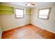 Bright bedroom featuring hardwood floors, built-in shelving, and neutral walls at 2317 St Peter St, Indianapolis, IN 46203
