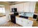 Updated kitchen featuring sleek, white cabinetry and stainless-steel appliances at 2317 St Peter St, Indianapolis, IN 46203