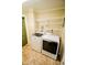 Convenient laundry area equipped with a washer, dryer, and ample shelving space at 2317 St Peter St, Indianapolis, IN 46203