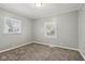 Spacious bedroom offering two windows, carpeted flooring, and neutral wall color at 2336 St Paul St, Indianapolis, IN 46203