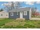 Charming home exterior showcasing the newly installed grey siding, white trim, and well-manicured lawn at 2336 St Paul St, Indianapolis, IN 46203