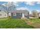 The newly renovated exterior featuring modern gray siding, white trim, and updated exterior features at 2336 St Paul St, Indianapolis, IN 46203