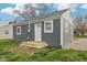 Home exterior showcasing the newly installed grey siding, white trim, and well-manicured lawn at 2336 St Paul St, Indianapolis, IN 46203