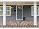Close-up of the front porch featuring the front door, white columns, and window at 2336 St Paul St, Indianapolis, IN 46203