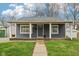 Charming home featuring a covered front porch with white columns and a gray exterior at 2336 St Paul St, Indianapolis, IN 46203