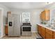 Well-lit kitchen with stainless steel appliances, wooden cabinets and a clean design at 2336 St Paul St, Indianapolis, IN 46203