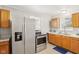 Modern kitchen with stainless steel refrigerator and classic-style wooden cabinets at 2336 St Paul St, Indianapolis, IN 46203